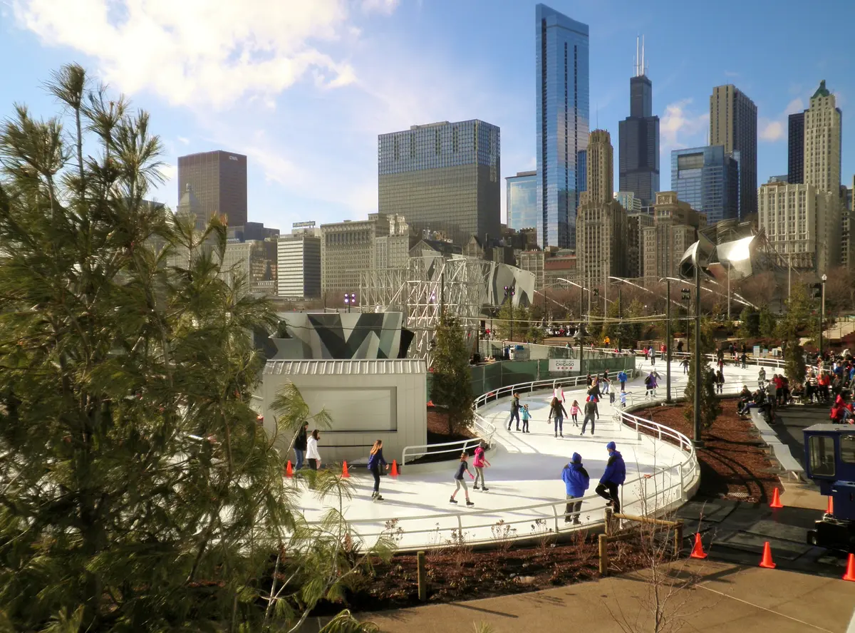 Skaters on the winding Maggie Daley Park Skating Ribbon in Chicago with the downtown skyline behind, December 2014