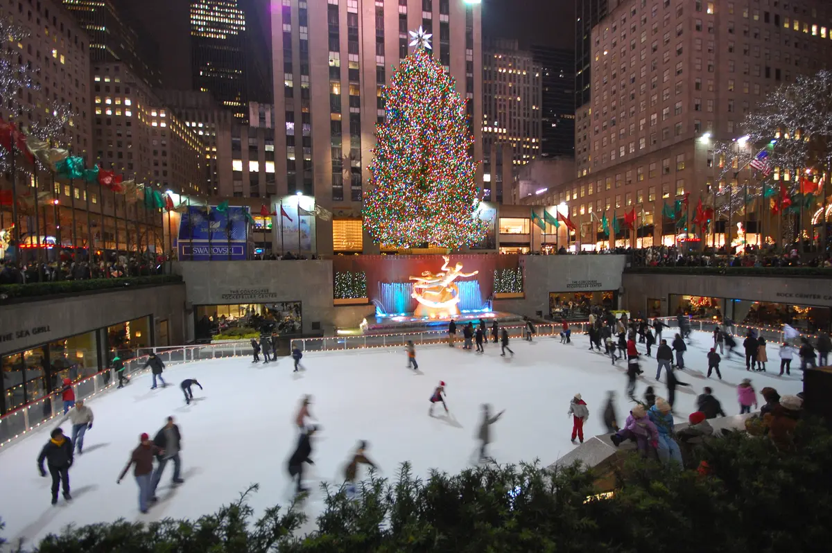Skaters at The Rink at Rockefeller Center in New York City beneath the Christmas tree and the Prometheus statue, December 2008